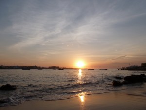 thanksgiving sunset watched perched on a beach rock on l'île de ngor just before sharing a gratitude-filled meal with friends and family forms