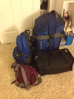 Big blue with a few of his friends, trusty backpack, tiny duffel (who comes along when six months is too many for big blue to carry alone), and hardy purse (who is a new addition, but who gets to see it all and has traveled many more miles as my daily companion), all packed up and ready to travel mile 40,955 to Senegal.  
